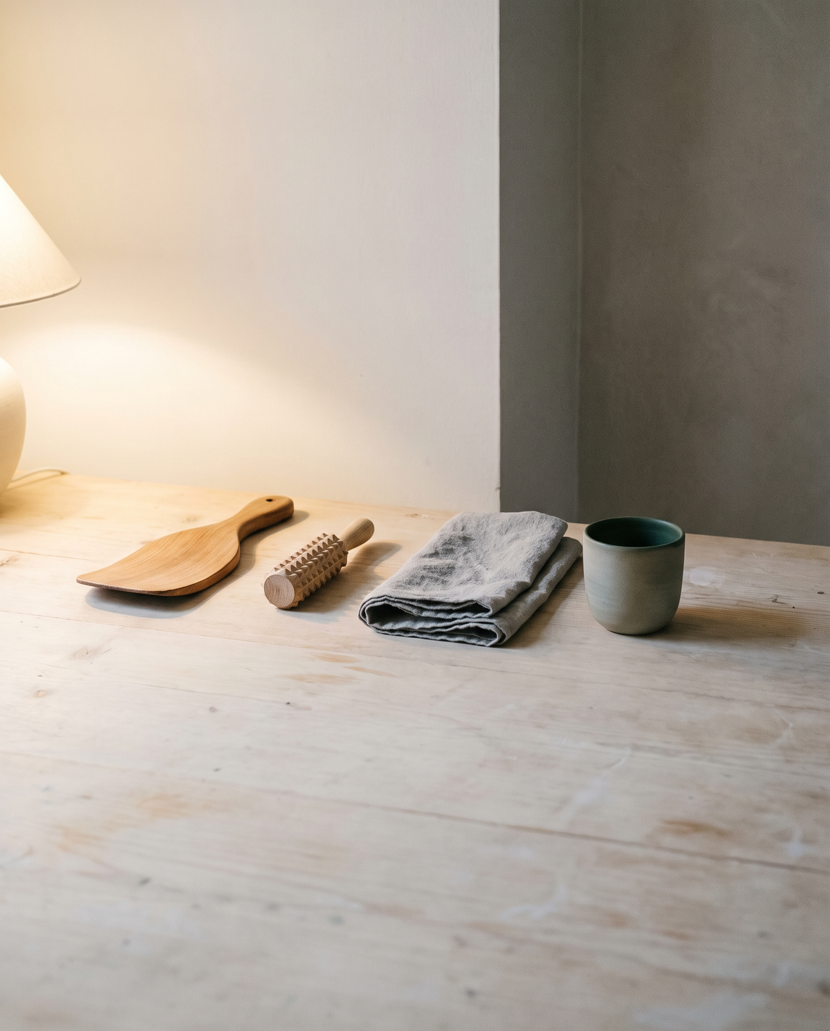 Home massage tools laid out on a pale wood table