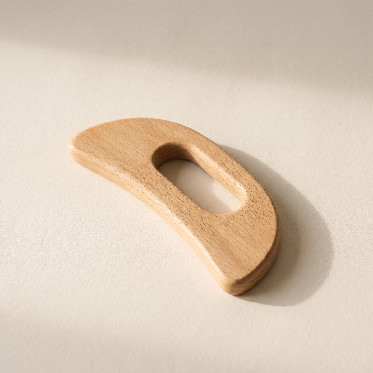 Beechwood body paddle on a warm off-white surface