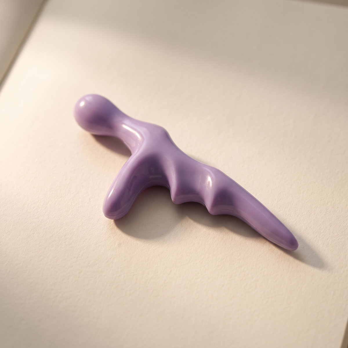 Trigger point tool on a warm off-white surface